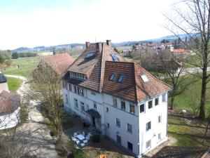 an aerial view of a large white house with a red roof at Altes Schulhaus in Argenbühl