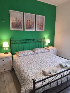 a green bedroom with a bed and two night stands at B&B near Lake Como - Close to train & bus - Breakfast included in Valmadrera +18 photos
