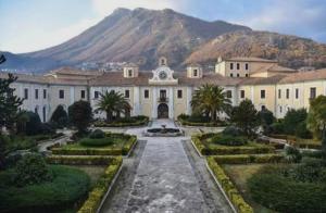 a large white building with a mountain in the background at B&B La Casa di Gastone in Mercogliano