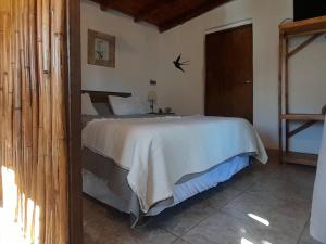 a bedroom with a large bed in a room at Monoambiente Golondrina in Capilla del Monte +28 photos