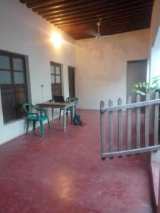 an empty room with a table and chairs in it at Magram House in Lamu