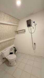a bathroom with a toilet and a shower at Cabin Mattias in Coron