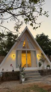 a small white house with a window and stairs at Cabin Mattias in Coron