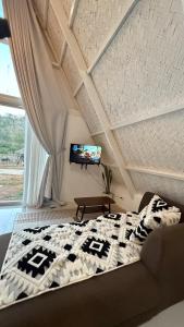 a bedroom with a bed and a flat screen tv at Cabin Mattias in Coron +14 photos