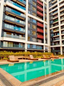 a swimming pool in front of a large apartment building at Nairobi Comfort Suites in Nairobi