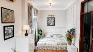 a bedroom with a bed and a dresser at Local Homestay in Hanoi
