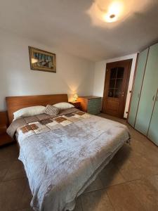 a bedroom with a large bed in a room at Chez Néné in Châtillon