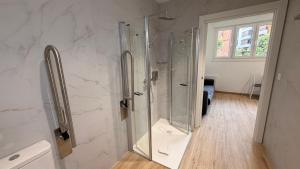 a bathroom with a shower with a glass shower stall at Apartamentos OKA Gernika in Guernica y Luno +25 photos