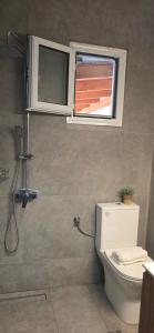 a bathroom with a toilet and a window at Chliara apartments by Tzalas in Skala Eresou +30 photos
