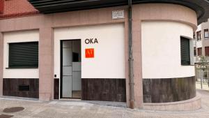 an office building with an osa sign on the door at Apartamentos OKA Gernika in Guernica y Luno