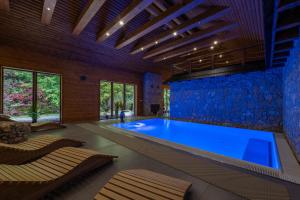 a large swimming pool in a room with a large blue tub at Jazierce in Ružomberok