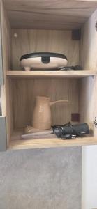 a shelf with a bowl and a pot on it at Chliara apartments by Tzalas in Skala Eresou