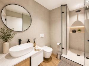 a bathroom with a sink and a toilet and a mirror at On Park Luxury One Bed & Bath- in Cape Town +41 photos
