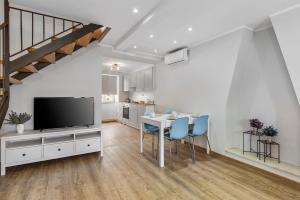 a living room with a dining room table and a television at Apartment Katja in Vantačići