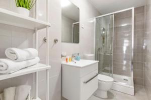 a white bathroom with a shower and a toilet at Apartment Katja in Vantačići +6 photos