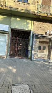 a garage with a gate on the side of a building at Edy Central Apartment in Arad