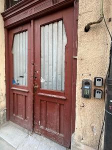 a red door with a cell phone in front of it at WOT Rose Residence in Arad
