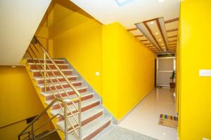a staircase in a room with yellow walls at Hotel Ram Janaki in Janakpur