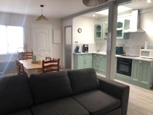 a living room with a couch and a kitchen at Mers in Mers-les-Bains