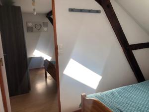 a room with a bedroom with a bed and a mirror at Mers in Mers-les-Bains