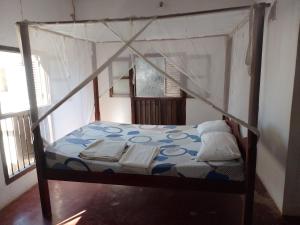 a bedroom with a bunk bed with a canopy at Magram House in Lamu