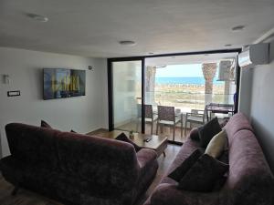 a living room with two couches and a view of the ocean at Dar Julia Seaview Apartment in Mahdia