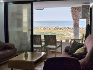 a living room with a view of the ocean at Dar Julia Seaview Apartment in Mahdia