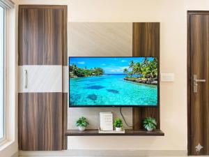 a flat screen tv hanging on a wall in a room at The verdant corner in Gurgaon