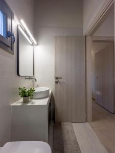 a bathroom with a sink and a mirror at THAλEIA Holiday Home in Nea Kallikrateia +120 photos