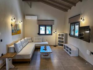 a living room with a couch and a table at THAλEIA Holiday Home in Nea Kallikrateia