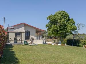 a house with a yard in front of it at THAλEIA Holiday Home in Nea Kallikrateia