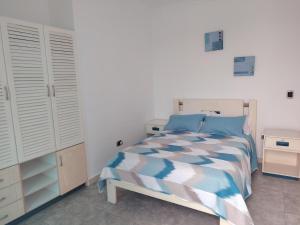 a bedroom with a bed with blue and white sheets at Casa suites golden in Tonsupa +7 photos