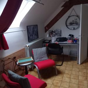 a room with a desk and chairs and a table at L'ABRI in May-sur-Orne