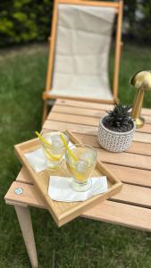 a wooden table with two glasses of lemonade on it at Gardenmode Airport Hotel in Taşoluk