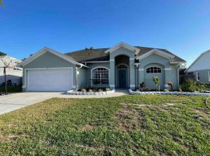 a large house with a garage at Spacious Home w heated Pool SmartTVs Pool Table in Riverview