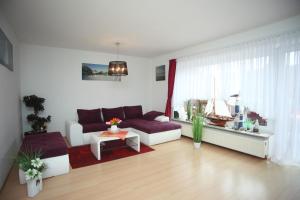 a living room with a couch and a table at Ferienhaus Victoria in Norden