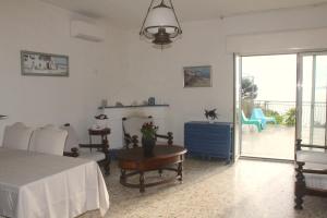 a bedroom with a bed and a table and chairs at Villa Torre in Acquafredda