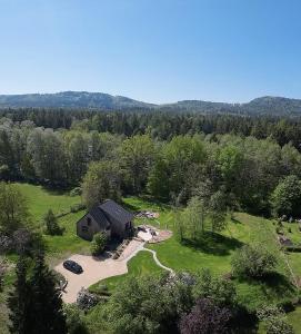 an aerial view of a house in the middle of a field at Foundation - Waldhaus mit Sauna & Hottub in Zittau