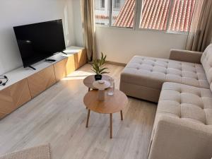 a living room with a couch and a table at Casa Feliz in Torrox Costa