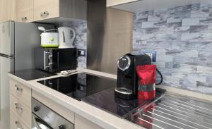a kitchen with a coffee maker on a counter at Giuly Sole e Sale in Le Grazie +13 photos