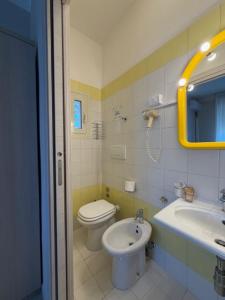 a bathroom with a toilet and a sink at Terme Palace Hotel in Montecatini Terme +26 photos