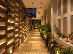 a hallway with potted plants in a building at Hotel Sugandh Retreat Near Bus Stand Jaipur in Jaipur