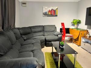 a living room with a couch and a table at Westcliff Cottage in Southend-on-Sea