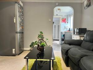 a living room with a couch and a table at Westcliff Cottage in Southend-on-Sea