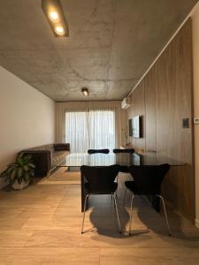 a living room with a table and chairs and a couch at Concepto Home in Rafaela
