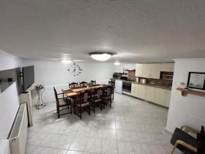 a kitchen and dining room with a table and chairs at Haraplak in Hajdúszoboszló +16 photos