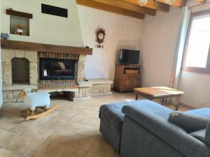 a living room with a couch and a fireplace at L'évasion Monplaisir in Gère-Belesten