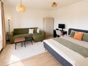 a bedroom with a bed and a couch at Moderní studio s terasou v klidné lokalitě in Jihlava