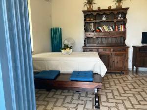 a bedroom with a bed and a wooden book shelf at Villa Torre in Acquafredda