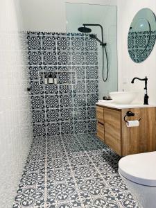 a bathroom with a shower and a sink at Coco's Bungalow in Mudgee +16 photos